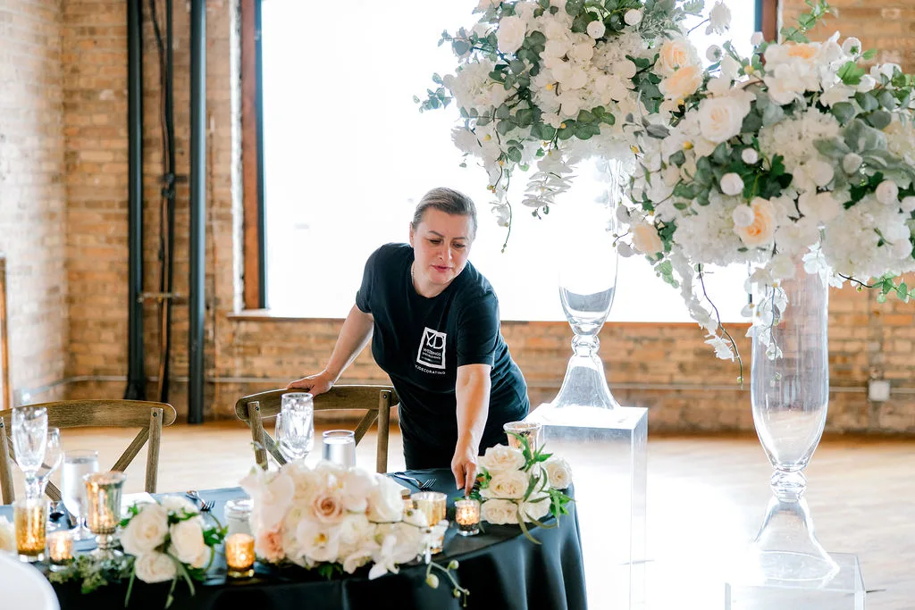 The master florist styling a sweetheart table at a Chicago loft — YJDecorating